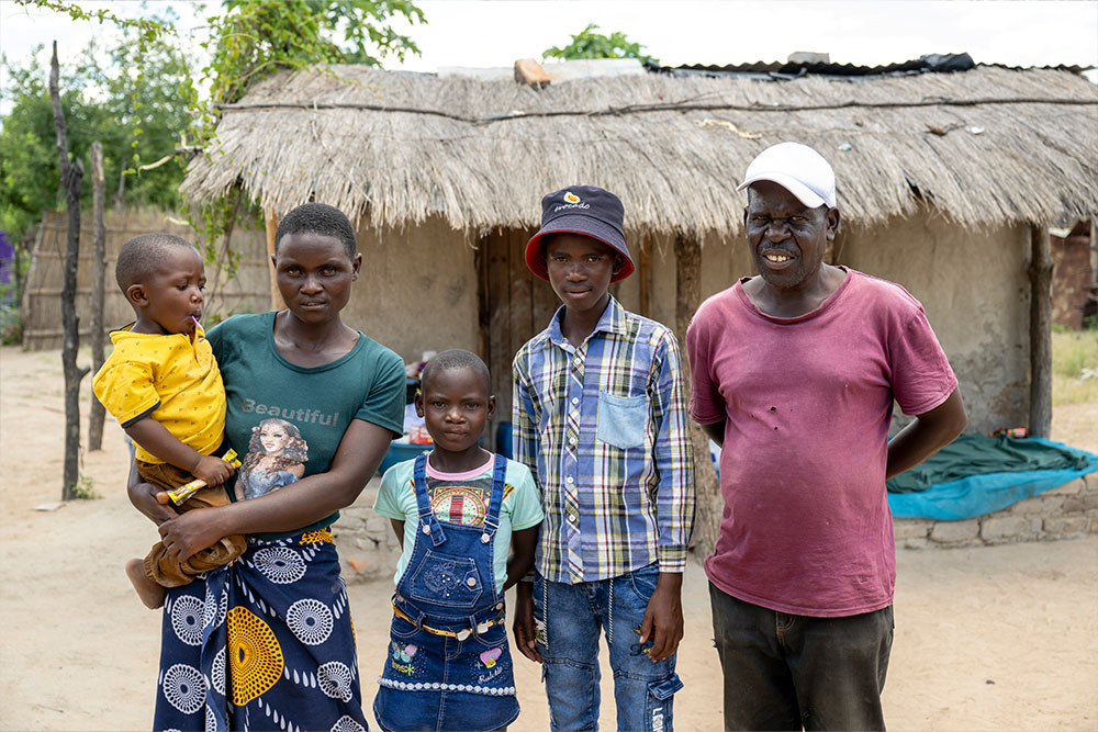 Siriza and Janerose smiling with March and two of her other children