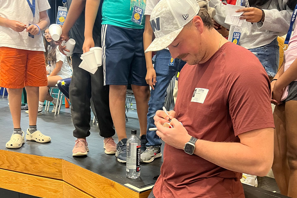 John Bates signing autographs for students