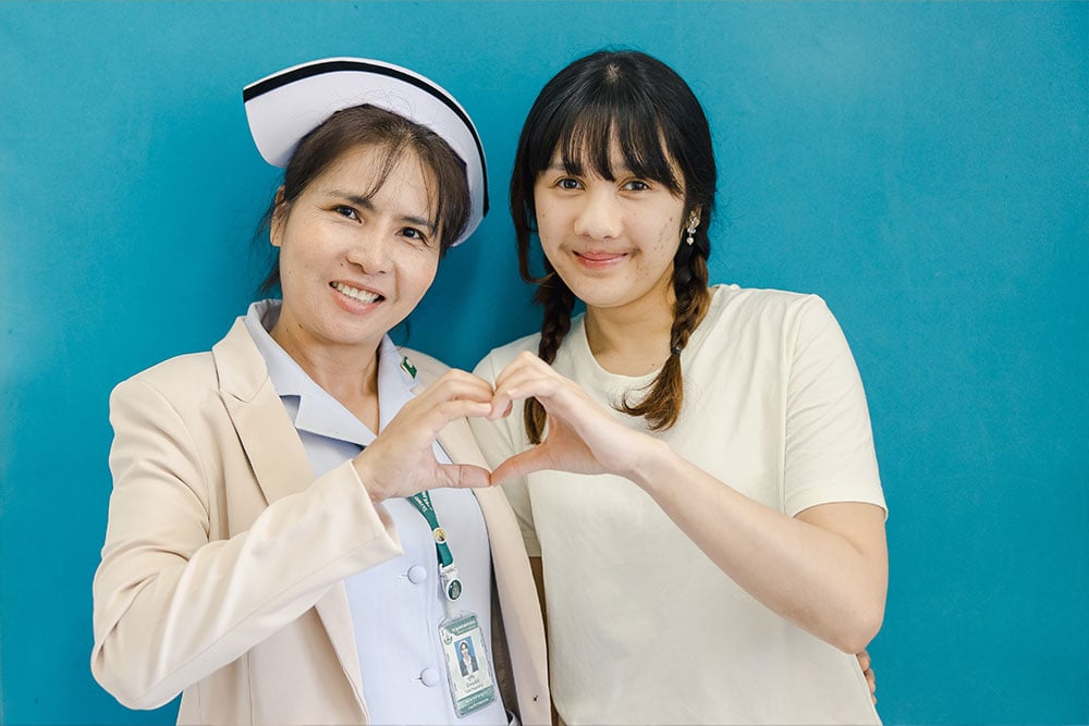 Nurse Yupin with a teenage patient