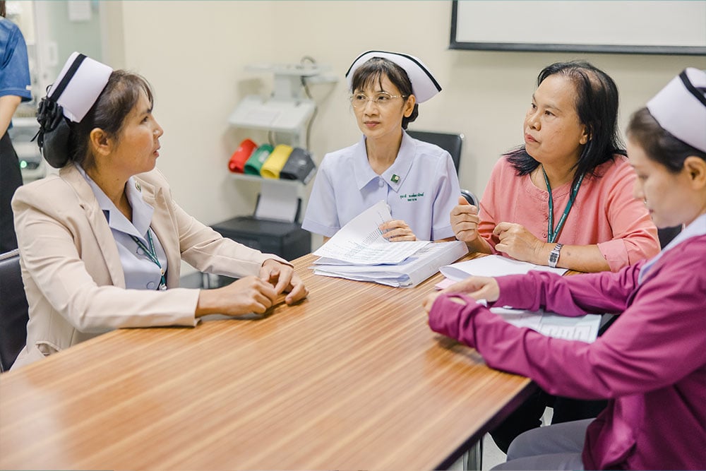 Nurses Yupin and Suteera meeting with other nurses