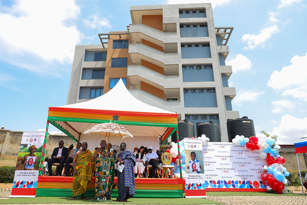 Exterior of National Cleft Care Center – A Smile Train Cleft Leadership Center with the speakers’ tent in the foreground for the opening ceremony