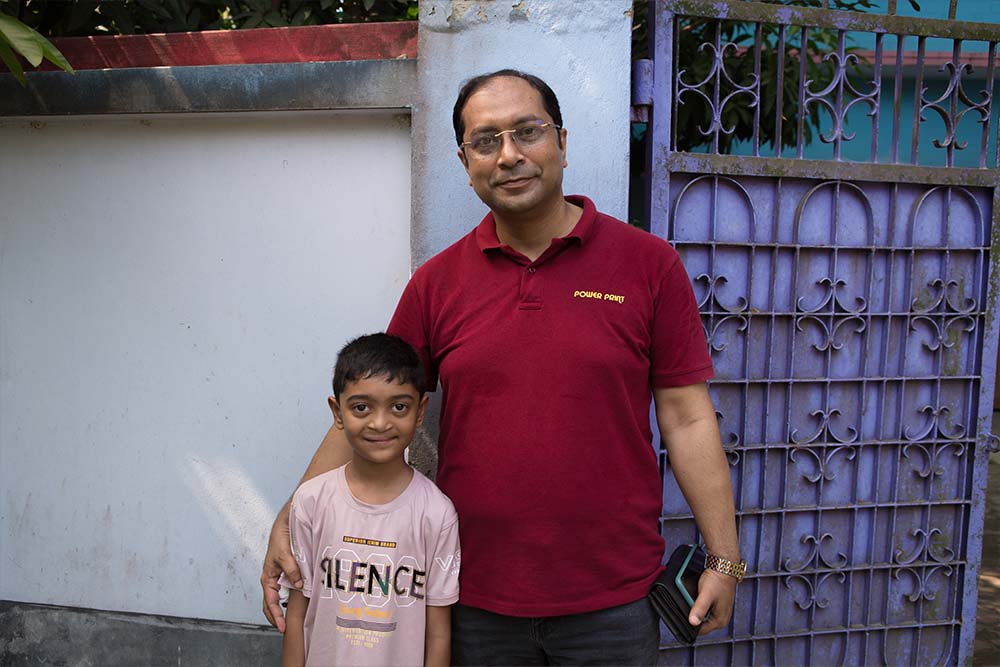 Maimun smiles and stands with Dr. Tarikul