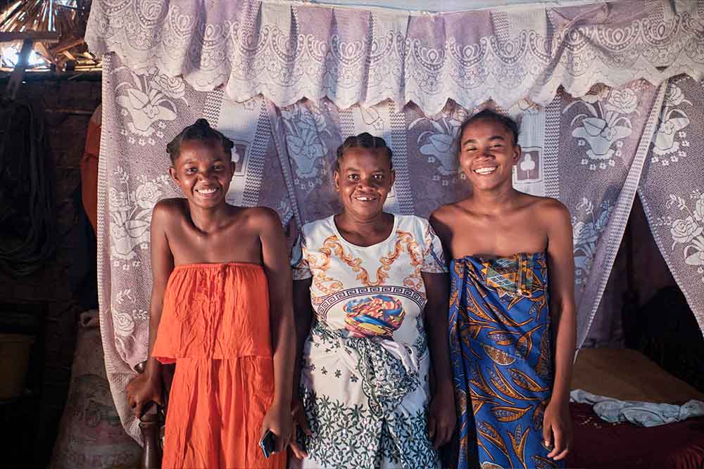 Rasoafine smiles with her two daughters