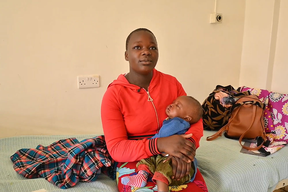 Catherine holds her baby, Benson, before receiving cleft surgery during World Cleft Awareness Day cleft week in Kisumu, Kenya