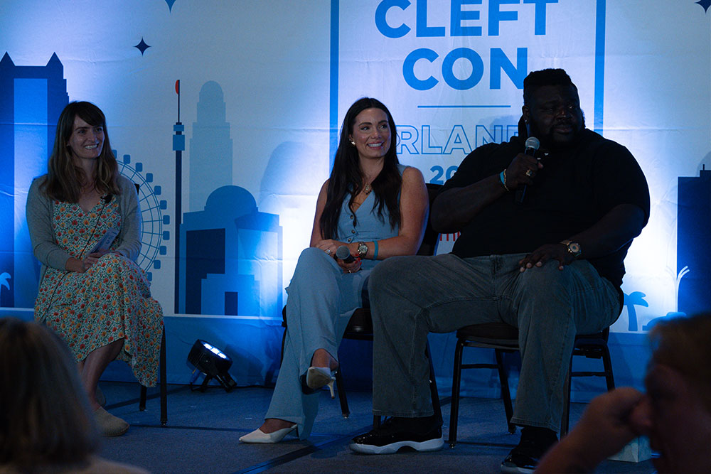 Adina, Isaac, and Autumn smile as an audience member asks a question during their panel