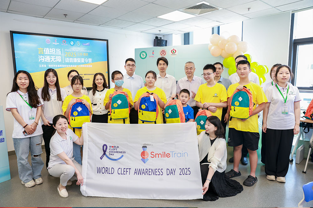 Group shot of speech camp participants behind a World Cleft Awareness Day 2025 banner