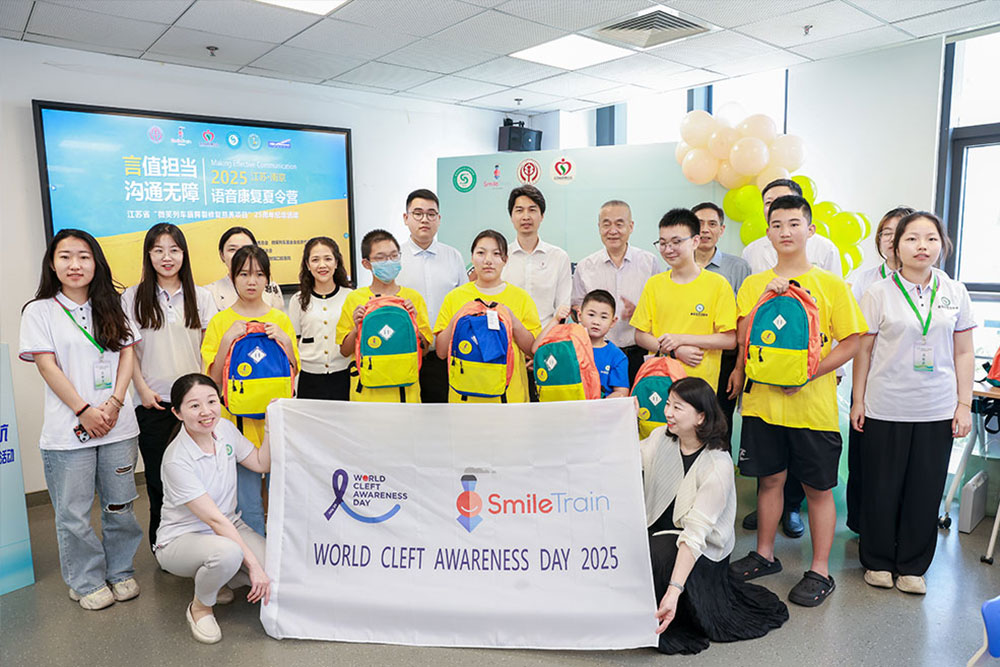 Group shot of speech camp participants behind a World Cleft Awareness Day 2025 banner