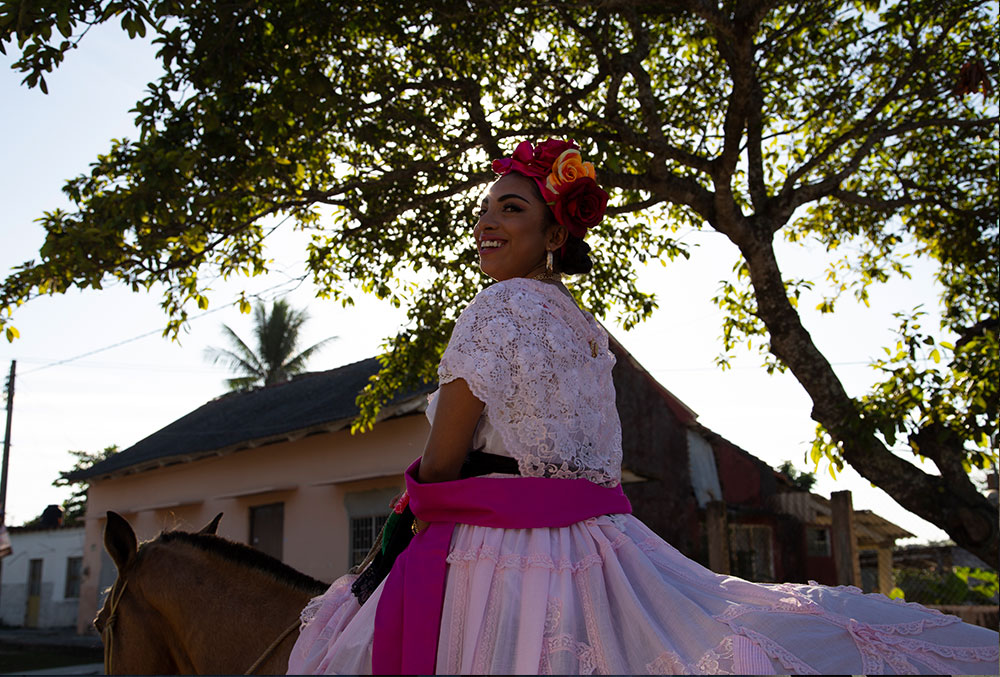 Adahara rides a horse dressed in traditional Mexican fashion after cleft lip and cleft palate treatment.