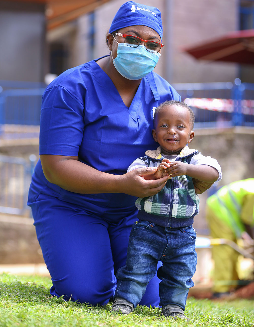 Dr. Malungo standing with a patient who had cleft lip and cleft palate surgery in Lusaka, Zambia.