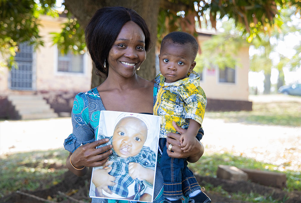 Annointed with his mother, who is holding a picture of him before cleft surgery