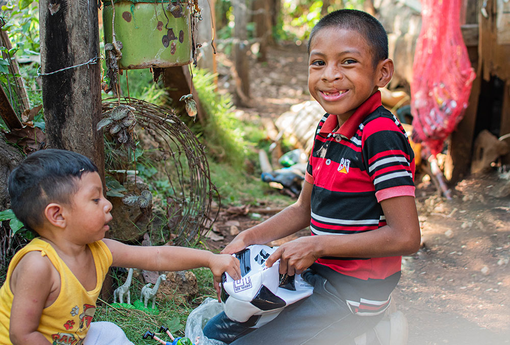 Auner and his brother play with a soccer ball after Auner's free cleft lip and palate treatment in Guatemala