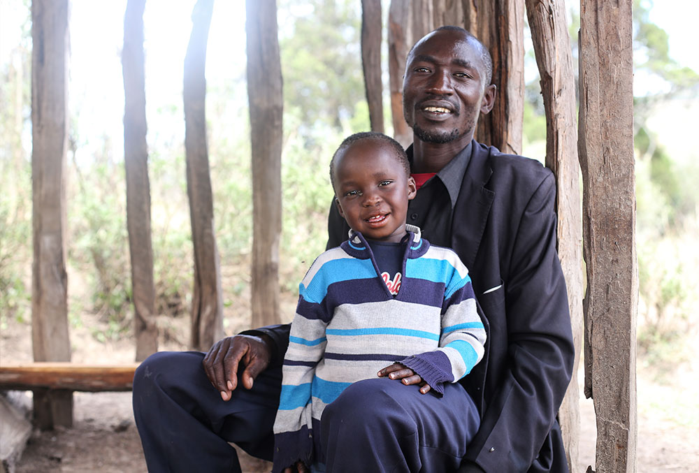 Benjamin sits in his father's lap