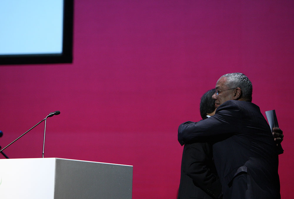 Colin Powell and Smile Train founder Charles B. Wang share a hug
