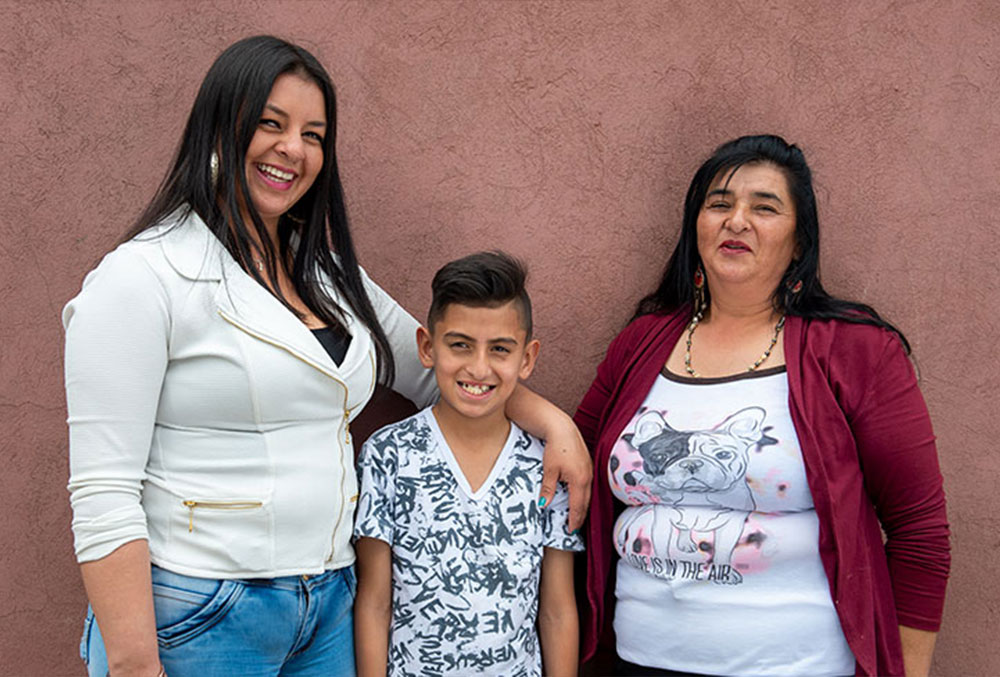 Cristian with his mother and grandmother