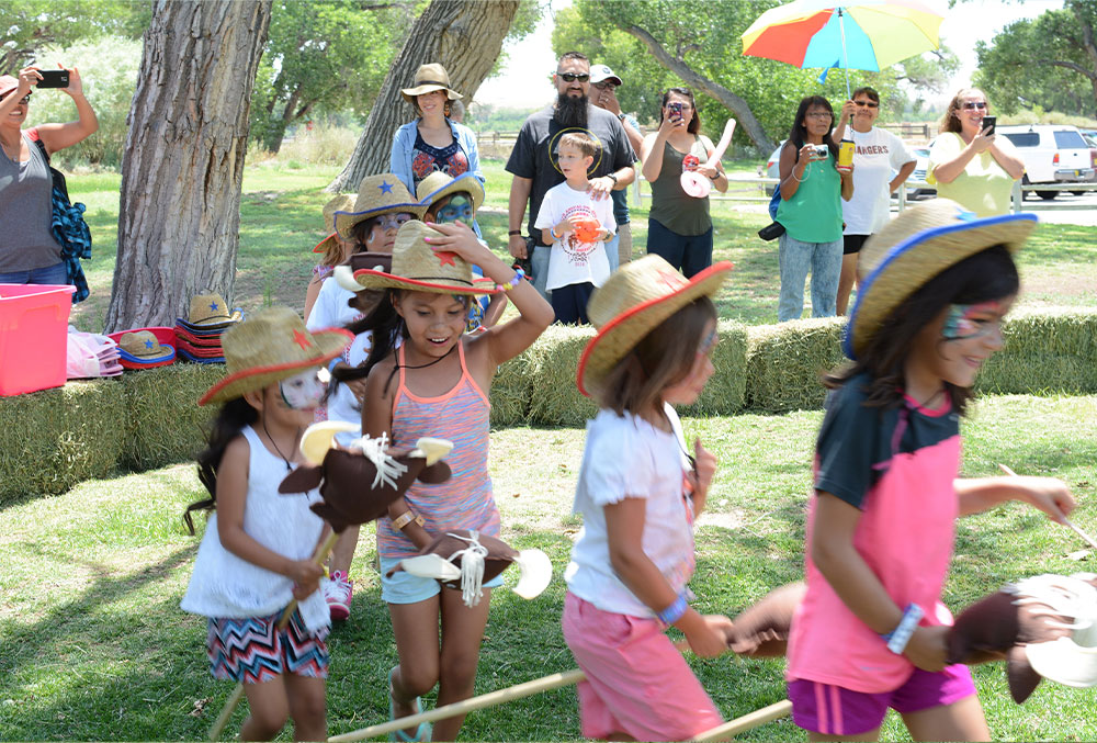 New Mexican children with cleft lips and cleft palates ride stick horses at Smile Fest