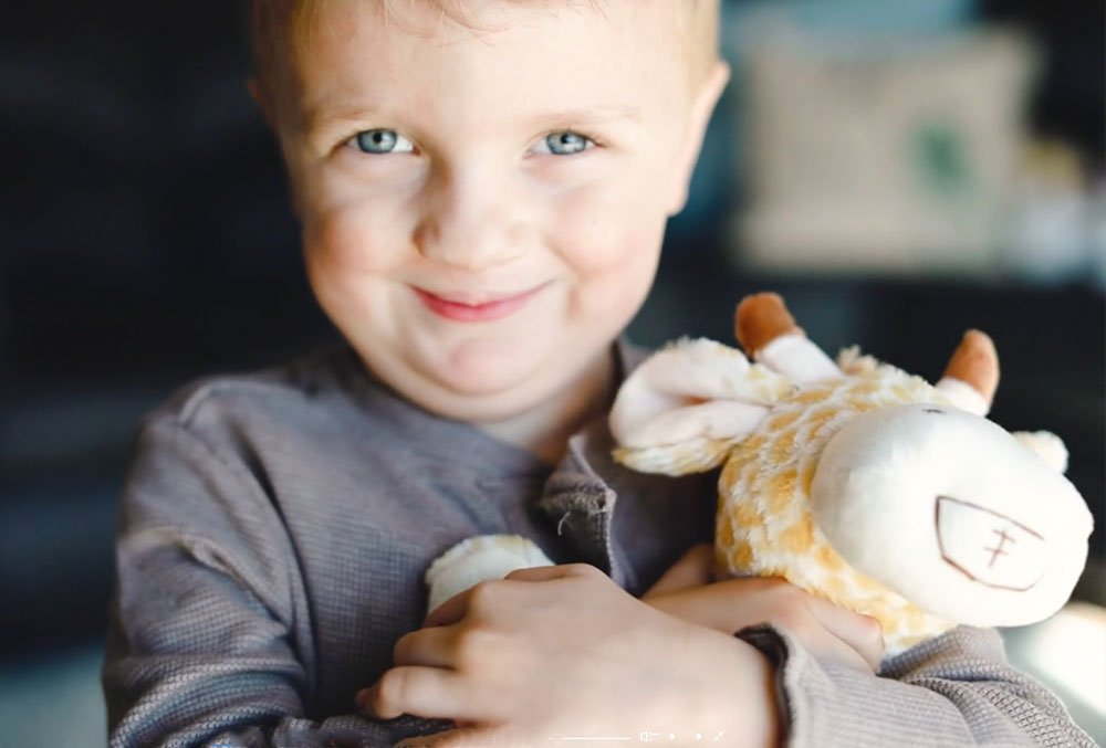 Krista's son cuddling his giraffe with a cleft