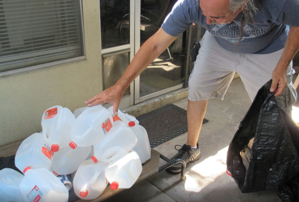 Dana's husband picking up recycling