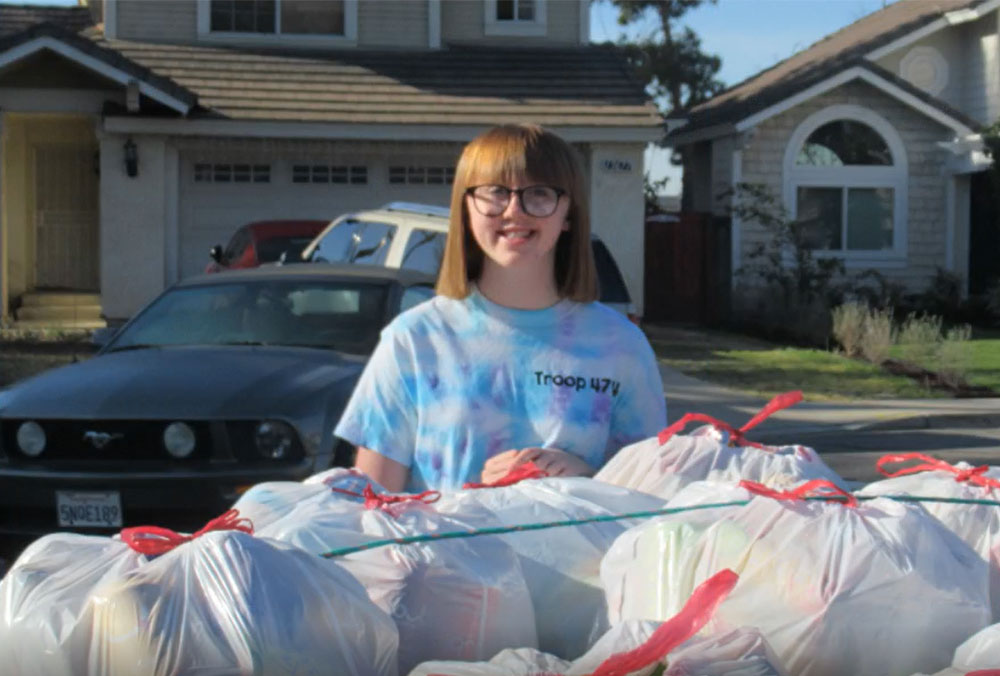 IPOLY student and Project Smile member with the recycling she collected for Smile Train