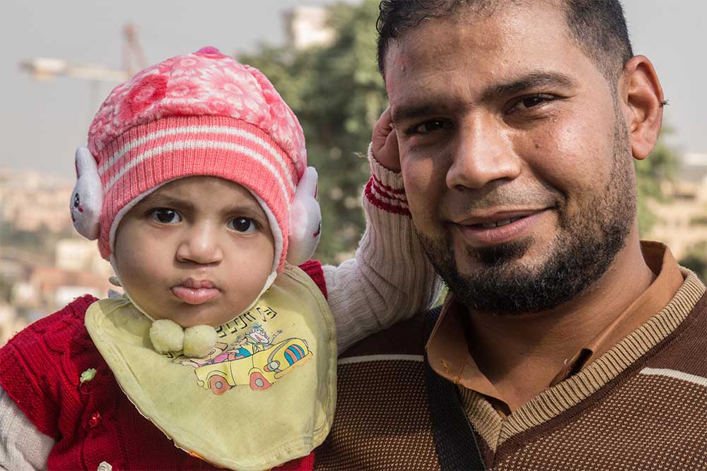 Habeeba held by her father