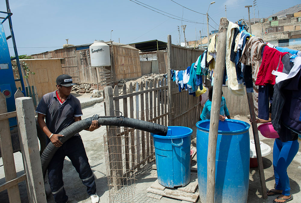 The water truck driver fills up Zindia's tank