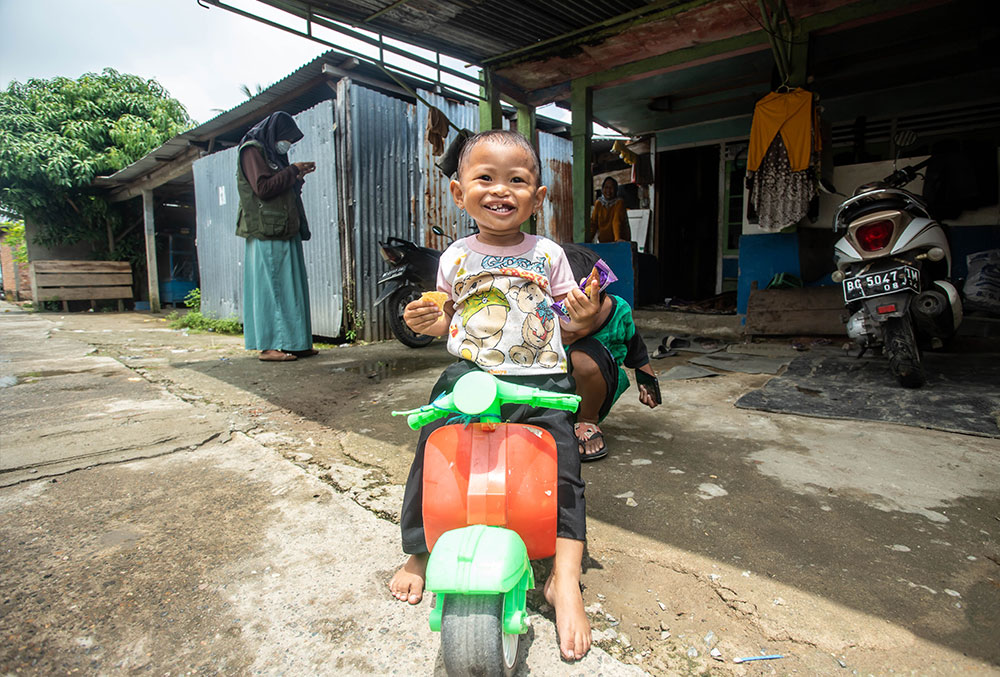 Karina rides a moped after her free Smile Train-sponsored cleft surgery