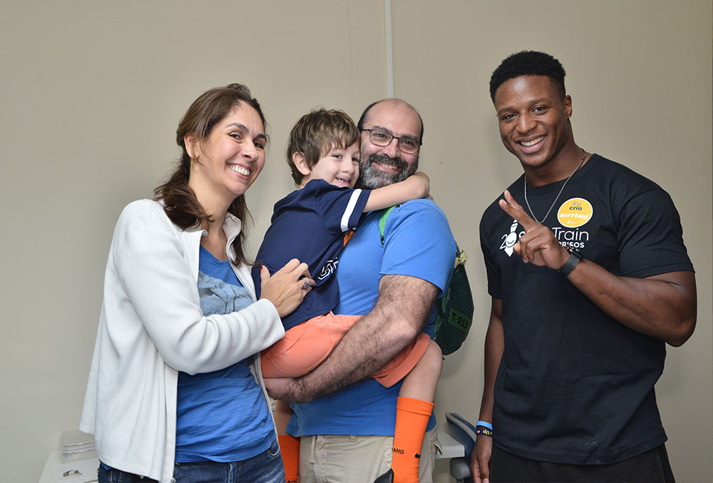 Kenyan Drake with a Smile Train patient and their family in Brazil