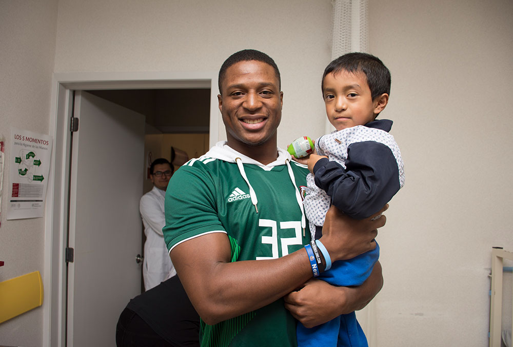 Kenyan Drake holds a cleft patient