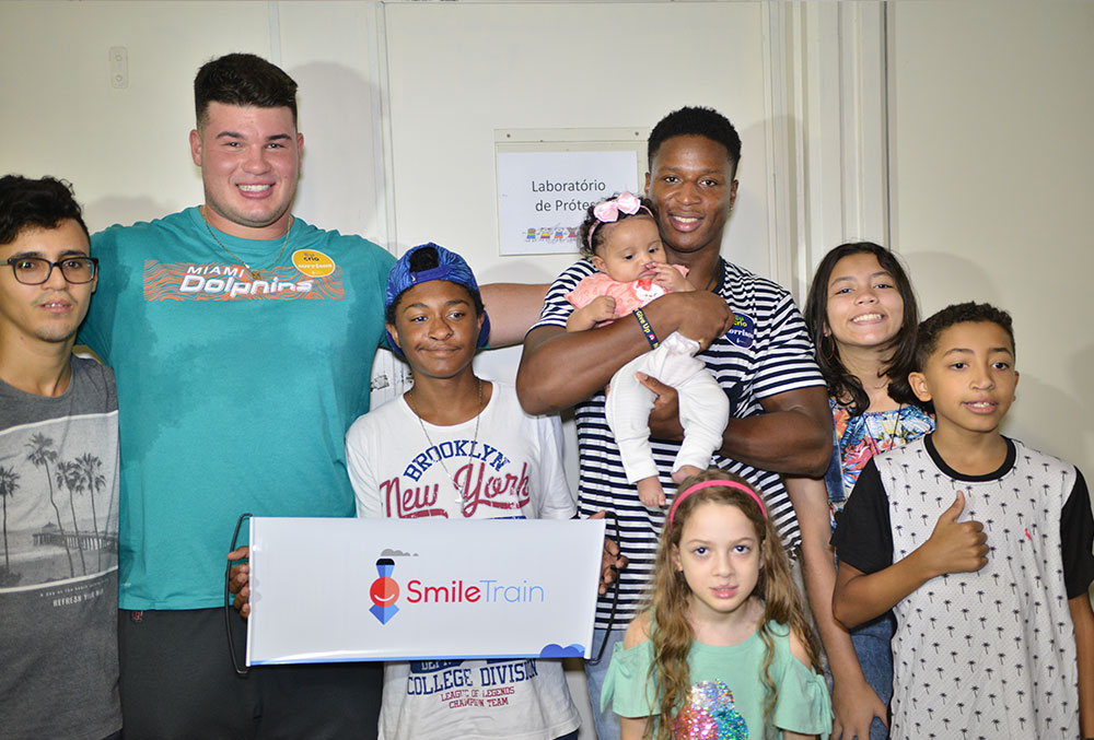 Kenyan Drake and Durval Queiroz Neto with Smile Train patients in Brazil