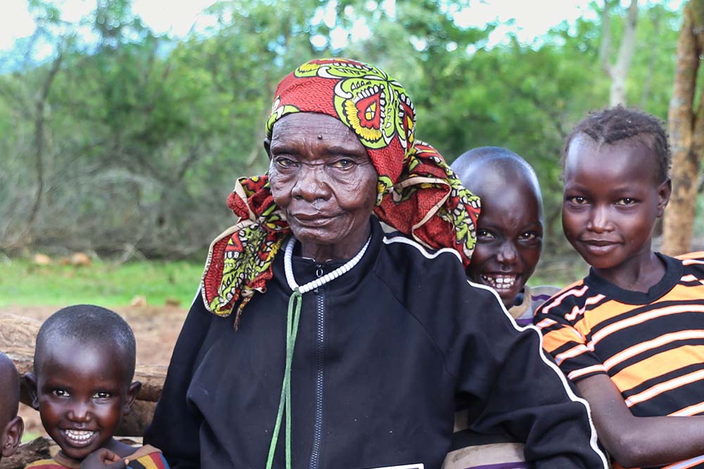 Maria smiles with her grandchildren