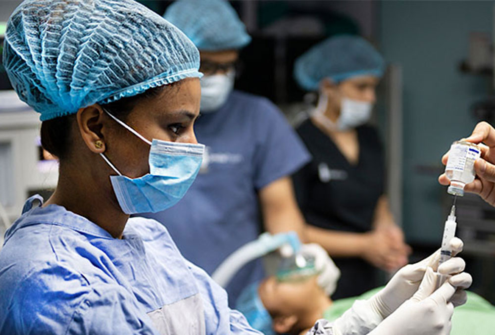 Smile Train partner cleft surgeon with a syringe.