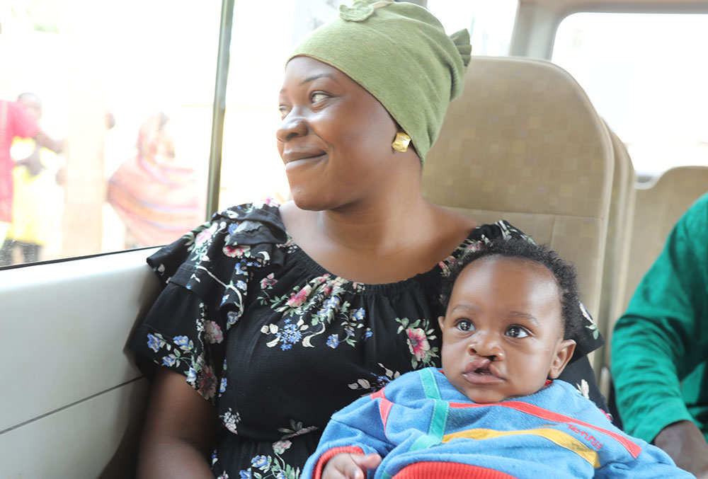 Mouhamed and his mother traveling to St. Dominique for free cleft care