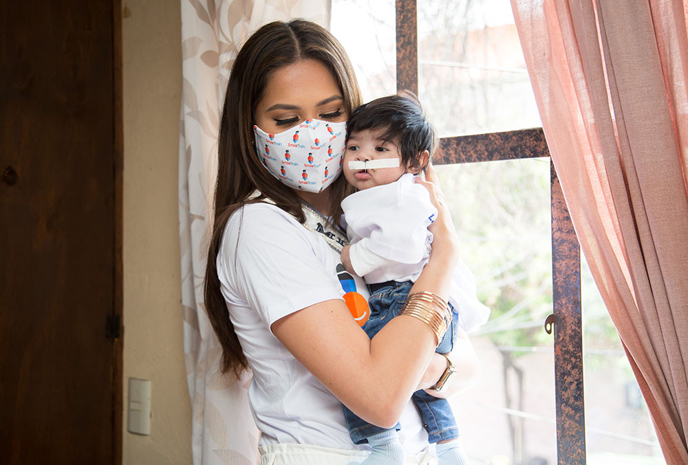 Miss Universe Andrea Meza holds Smile Train cleft patient Roberto in Mexico