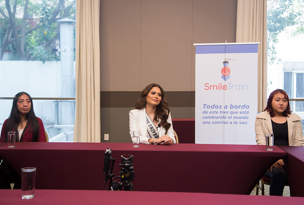 Miss Universe Andrea Meza sits on a Smile Train panel in Mexico