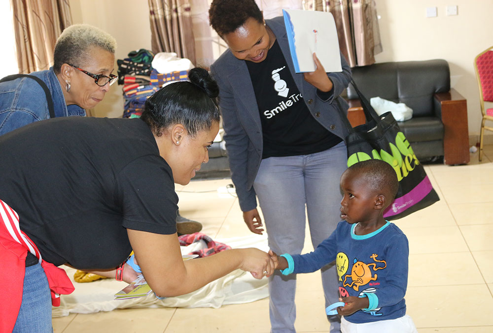 Nijha and her mother interact with a Smile Train cleft patient in Kenya