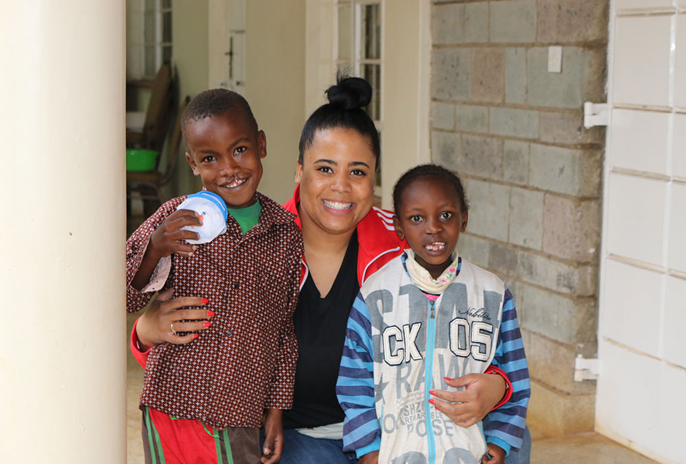 Nijha smiles with two Smile Train patients just after their free cleft surgeries in Kenya