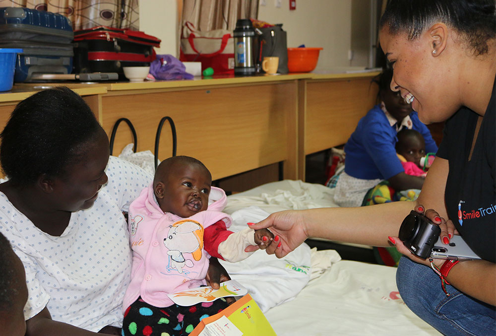 Nijha with a baby just after her free Smile Train-sponsored cleft surgery in Kenya