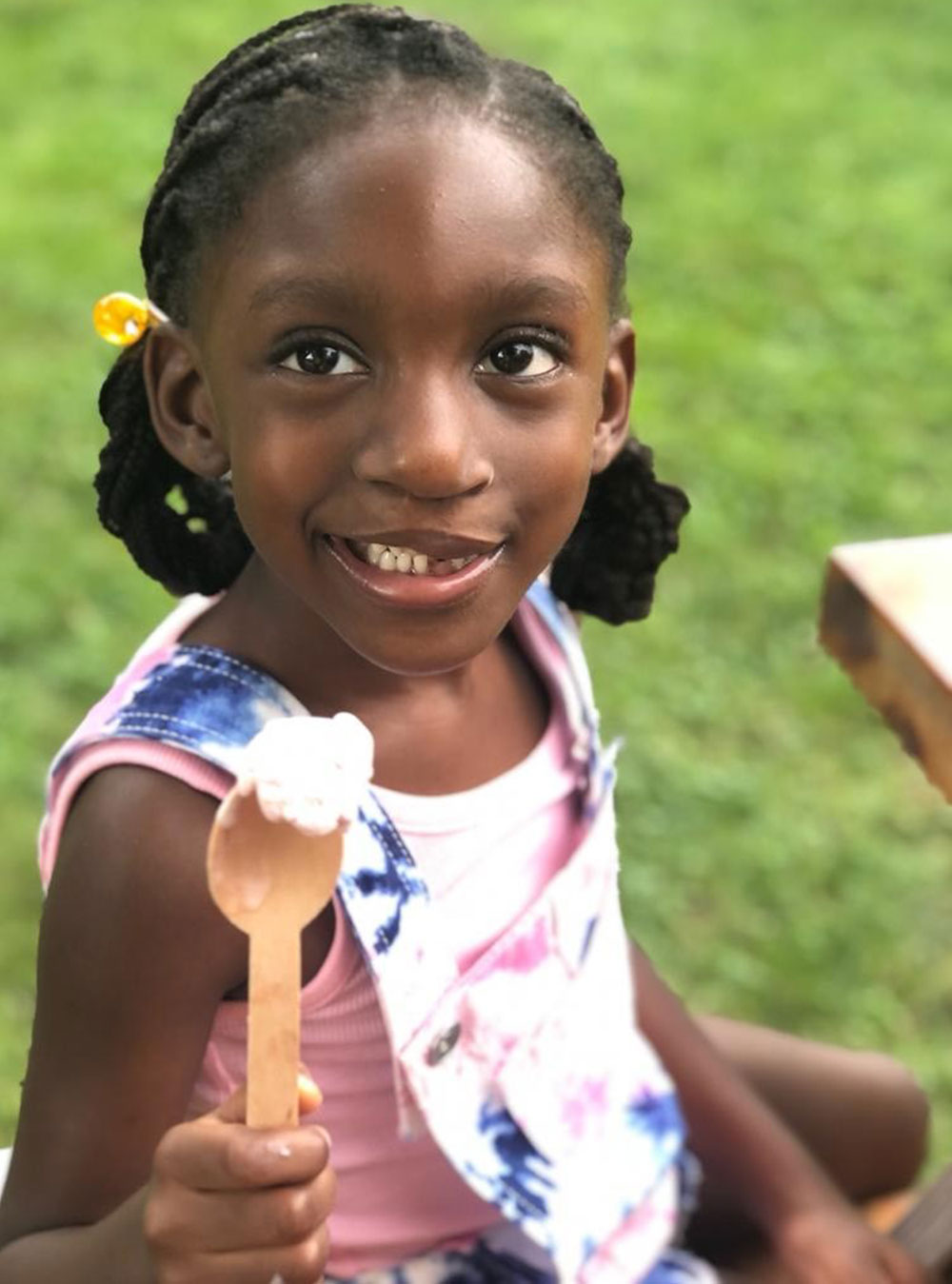 Norah licks a spoon on a hot summer day