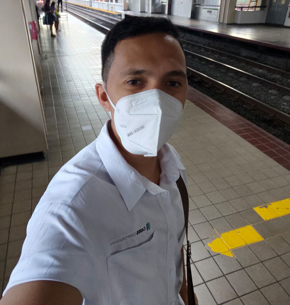 Santi takes a selfie on a subway station in Manila