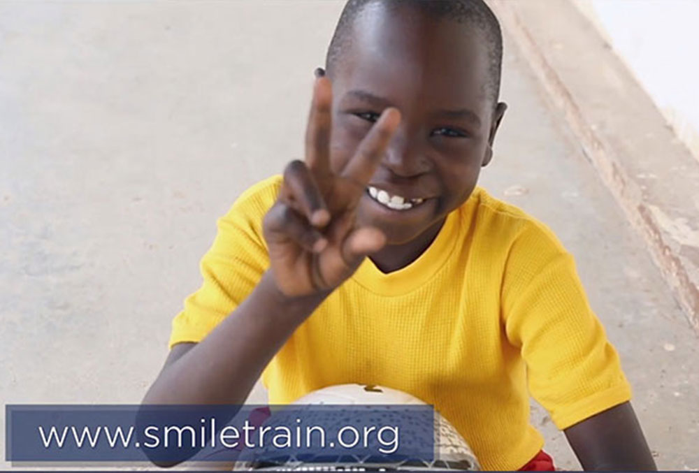 Smile Train patient Osawa from Tanzania flashes a peace sign on 'Selena + Chef'