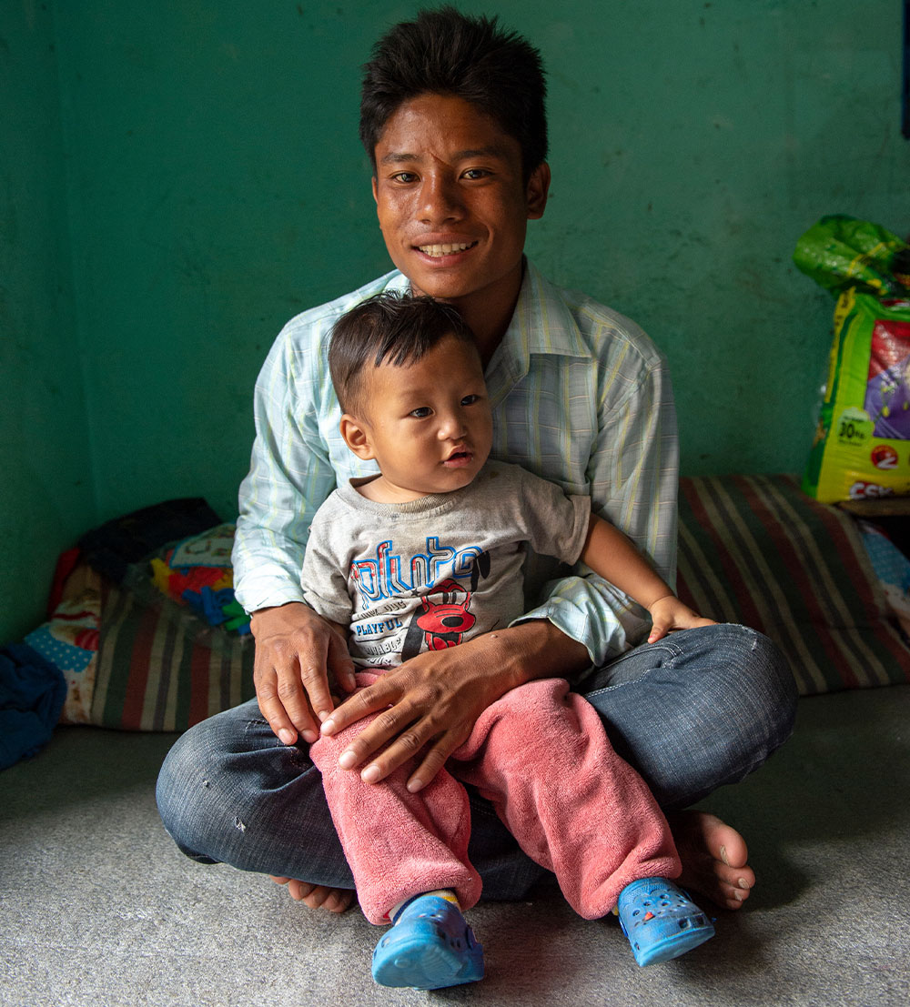 Smile with his father after his free Smile Train cleft surgery in Nepal