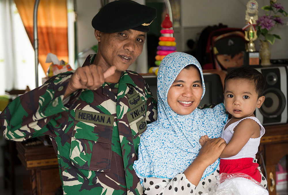 Zawata with family after free cleft lip palate surgery in Indonesia