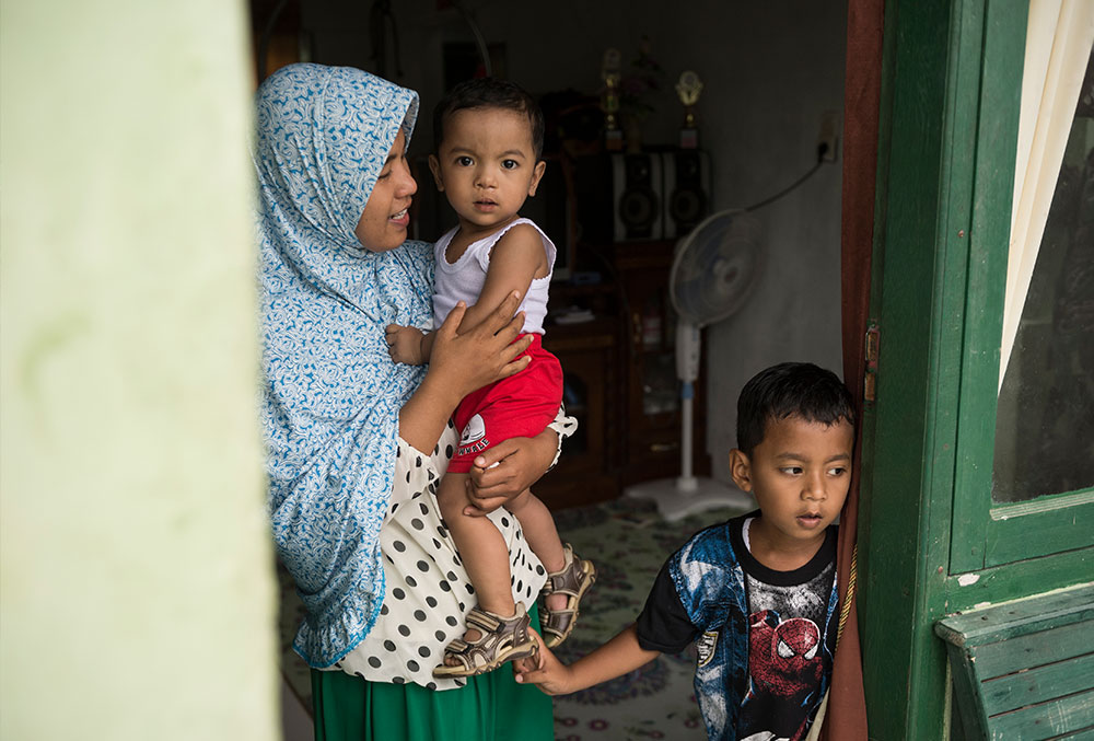 Zawata with mother and brother after free Smile Train cleft treatment in Indonesia