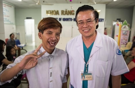 Smile Train doctor next to his happy patient