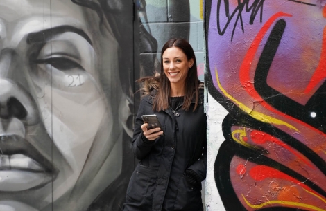 Christine Smessaert in front of graffiti