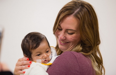 Cleft community advisory council member holding baby