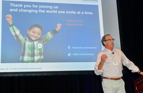 Man gives company presentation about Smile Train