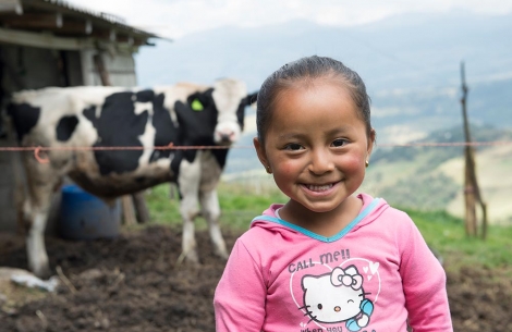 Fernanda stands in front of a cow