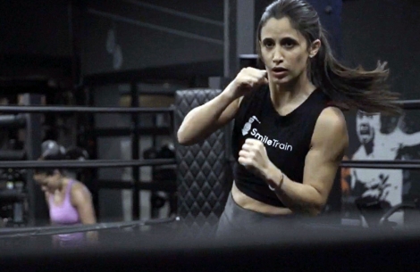 Jennifer Jacobs boxing in a Smile Train tanktop