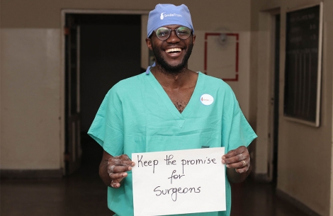 Surgeon holding up sign for social media campaign