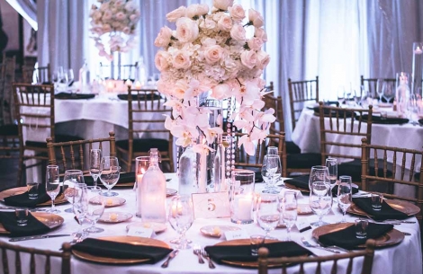 A wedding setting of plates and flowers